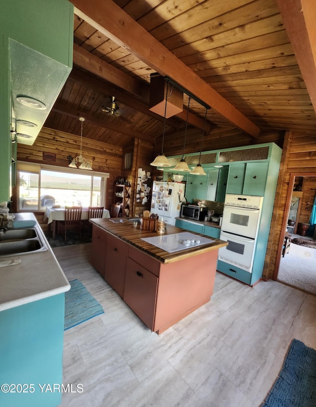 13520 Fisk Rd, Yakima, WA 98908 - kitchen with white appliances, wooden ceiling, wood walls, a kitchen island, and decorative light fixtures
