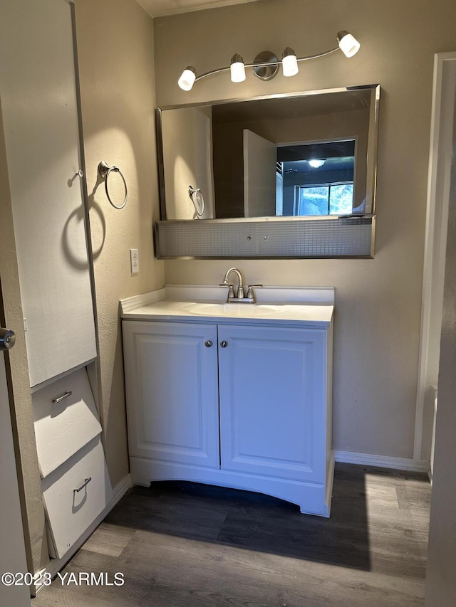 205 N 63rd Ave, Yakima, WA 98908 - bathroom with wood finished floors, baseboards, and vanity