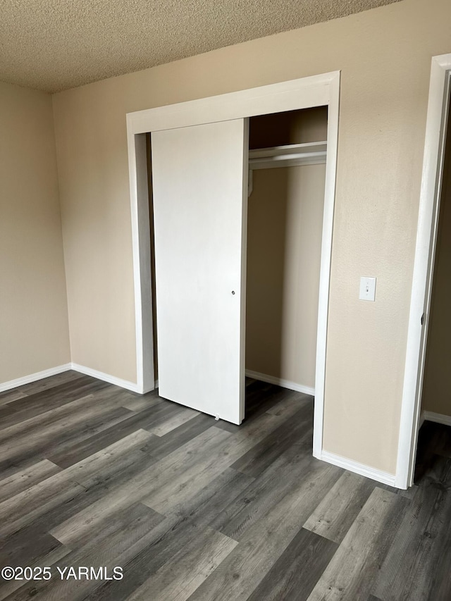 205 N 63rd Ave, Yakima, WA 98908 - unfurnished bedroom with dark wood-style floors, a closet, baseboards, and a textured ceiling