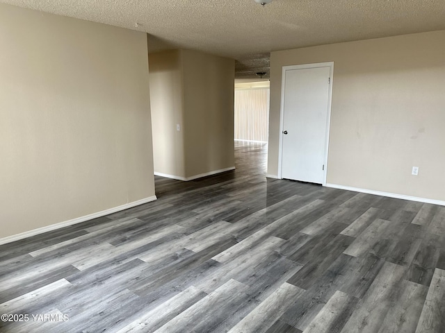205 N 63rd Ave, Yakima, WA 98908 - unfurnished room with a textured ceiling, dark wood finished floors, and baseboards