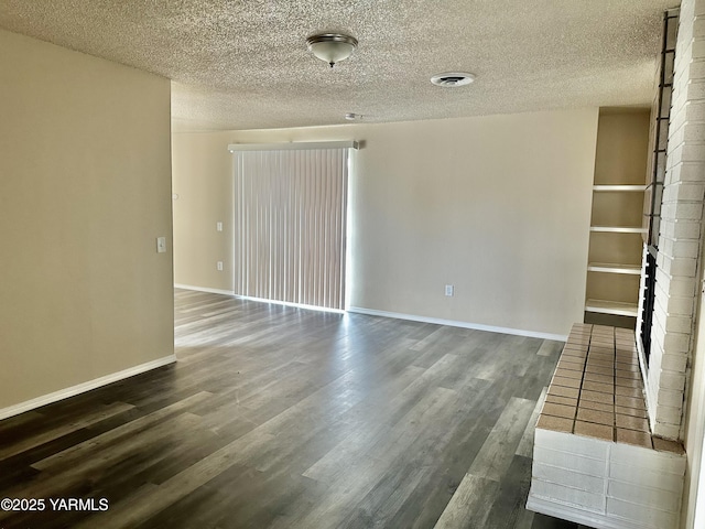 205 N 63rd Ave, Yakima, WA 98908 - spare room featuring a textured ceiling, wood finished floors, and baseboards