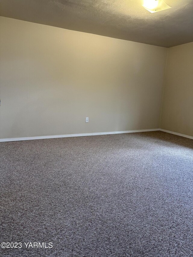 205 N 63rd Ave, Yakima, WA 98908 - carpeted empty room featuring baseboards
