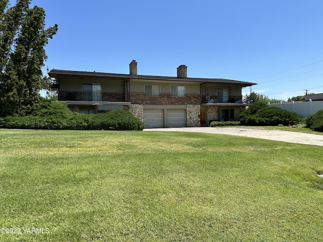 205 N 63rd Ave, Yakima, WA 98908 - view of front of home featuring a chimney, stone siding, driveway, and a front yard