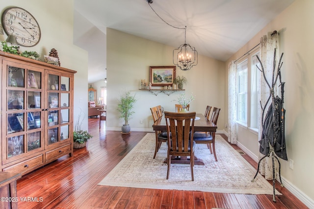 1008 S 90th Ave, Yakima, WA 98908 - dining area featuring vaulted ceiling, wood finished floors, a chandelier, and baseboards