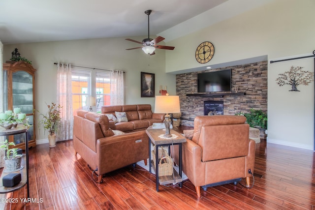 1008 S 90th Ave, Yakima, WA 98908 - living area with wood finished floors, ceiling fan, a stone fireplace, baseboards, and high vaulted ceiling