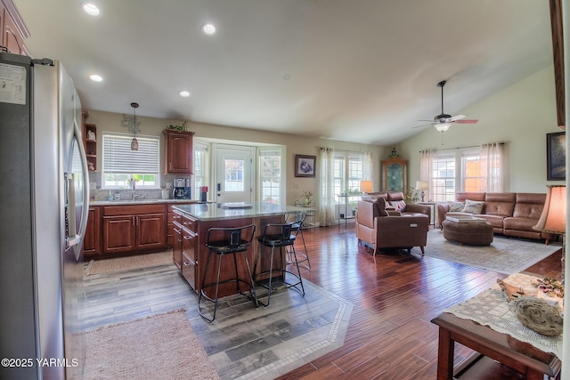 1008 S 90th Ave, Yakima, WA 98908 - kitchen with freestanding refrigerator, plenty of natural light, a center island, a kitchen bar, and recessed lighting