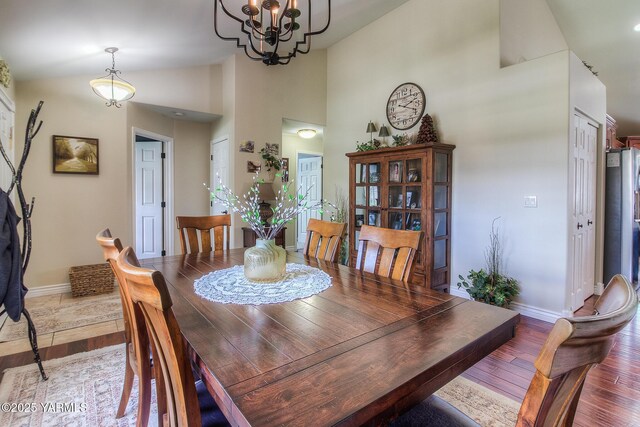 1008 S 90th Ave, Yakima, WA 98908 - dining space featuring baseboards, light wood finished floors, a chandelier, and high vaulted ceiling