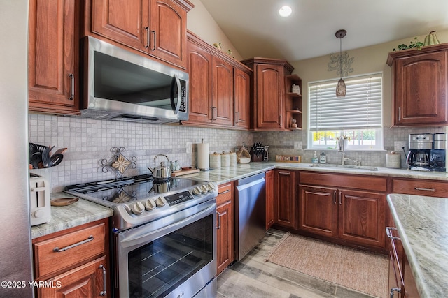 1008 S 90th Ave, Yakima, WA 98908 - kitchen with stainless steel appliances, a sink, tasteful backsplash, and decorative light fixtures