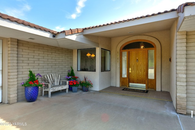 1011 N 42nd Pl, Yakima, WA 98908 - view of exterior entry with a tiled roof and stucco siding