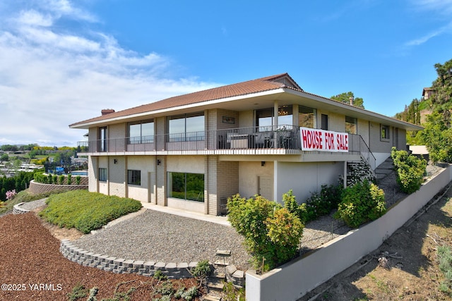 1011 N 42nd Pl, Yakima, WA 98908 - rear view of property featuring brick siding, stairway, stucco siding, and a balcony