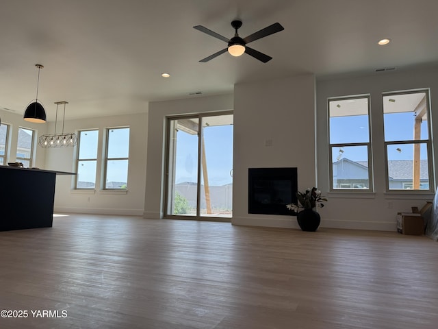 202 E Ian Ave, Ellensburg, WA 98926 - unfurnished living room featuring wood finished floors, a fireplace, ceiling fan, and recessed lighting
