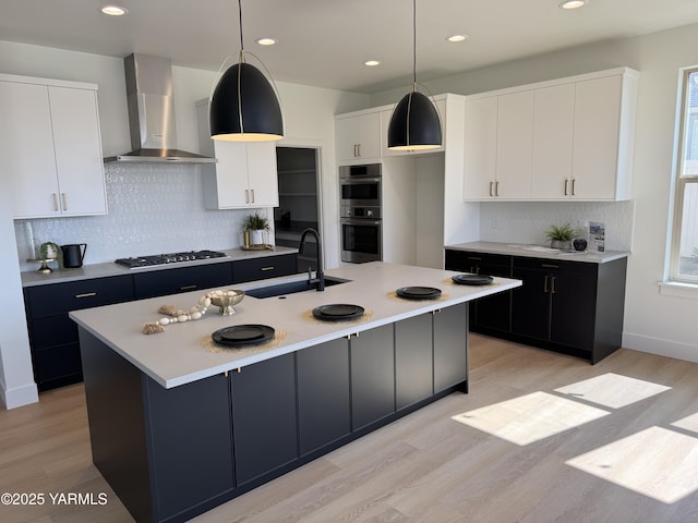 202 E Ian Ave, Ellensburg, WA 98926 - kitchen featuring wall chimney range hood, gas stovetop, double oven, light wood-style floors, and light countertops