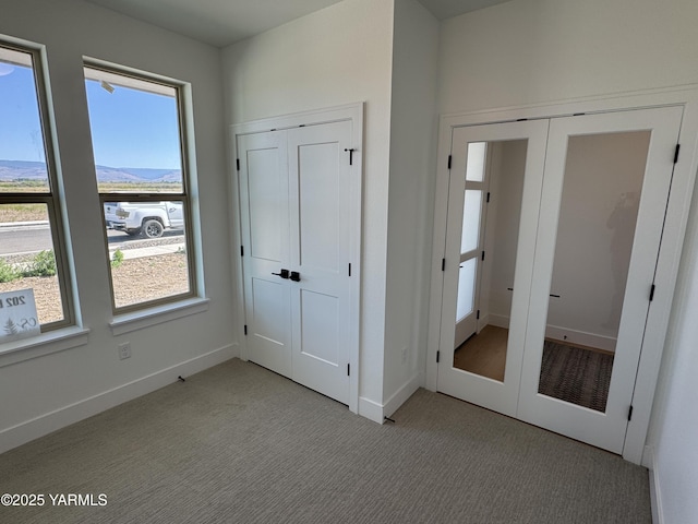 202 E Ian Ave, Ellensburg, WA 98926 - unfurnished bedroom with multiple windows, light colored carpet, and two closets