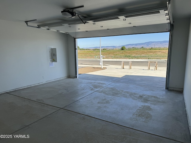 202 E Ian Ave, Ellensburg, WA 98926 - garage with a garage door opener, electric panel, and a mountain view