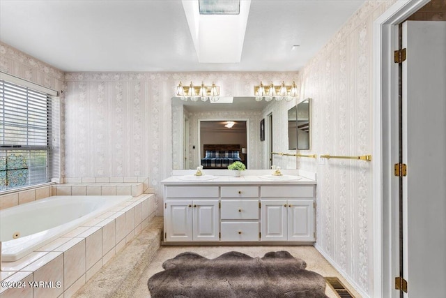 full bath with tiled tub, double vanity, a sink, and wallpapered walls