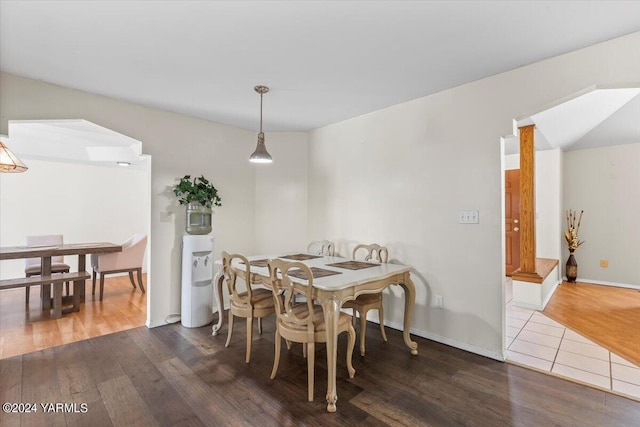 dining room featuring dark wood-style floors and baseboards