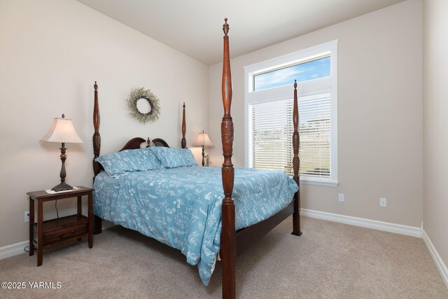 bedroom with baseboards and light carpet