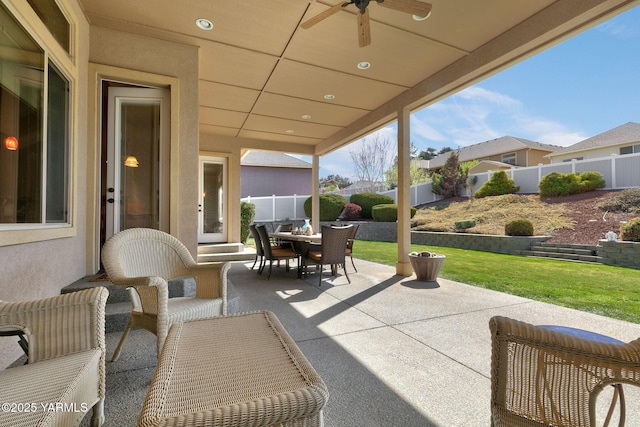 view of patio / terrace featuring a fenced backyard, a ceiling fan, and outdoor dining area
