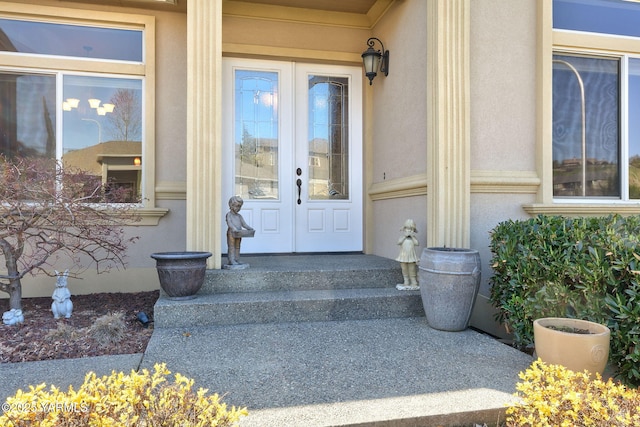 view of exterior entry with stucco siding