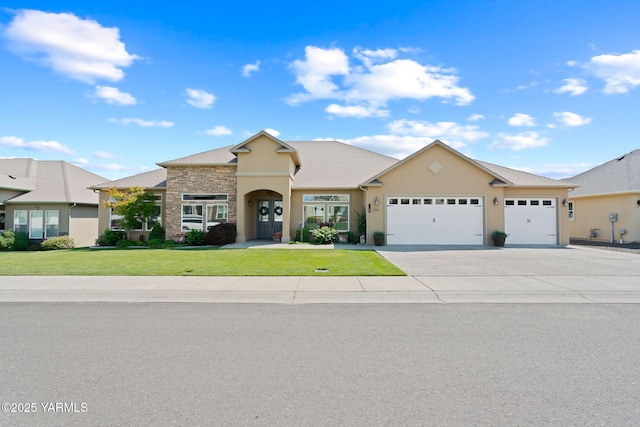 7506 Lyons Ln, Yakima, WA 98903 - view of front of house with a garage, a front yard, concrete driveway, stucco siding, and stone siding