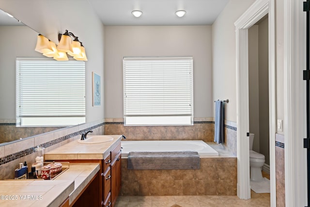 7506 Lyons Ln, Yakima, WA 98903 - bathroom featuring a bath, toilet, vanity, and tile patterned flooring