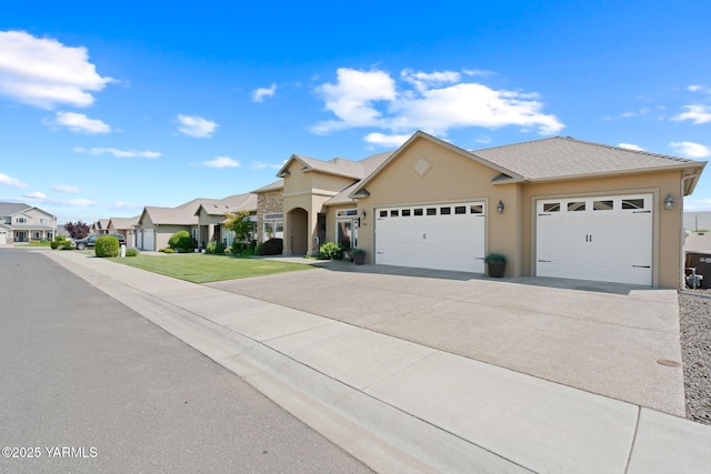 7506 Lyons Ln, Yakima, WA 98903 - view of front of house with concrete driveway, stucco siding, an attached garage, and a residential view