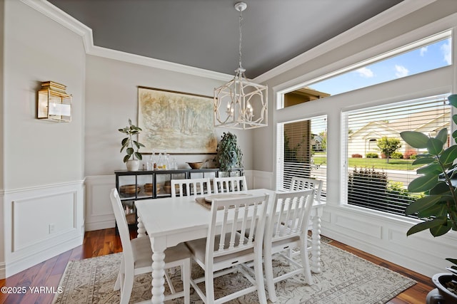7506 Lyons Ln, Yakima, WA 98903 - dining room featuring a chandelier, crown molding, a wainscoted wall, wood finished floors, and a decorative wall