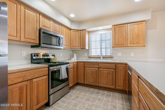 19 N 86th Ave, Yakima, WA 98908 - kitchen with recessed lighting, stainless steel appliances, light countertops, and a sink