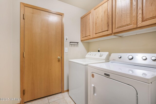 19 N 86th Ave, Yakima, WA 98908 - clothes washing area featuring washing machine and dryer, cabinet space, and light tile patterned flooring