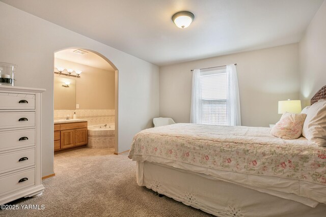19 N 86th Ave, Yakima, WA 98908 - bedroom with ensuite bath, arched walkways, visible vents, and light carpet