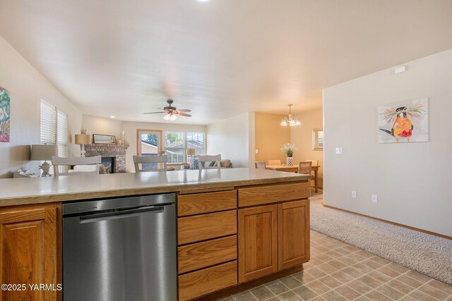 19 N 86th Ave, Yakima, WA 98908 - kitchen featuring ceiling fan with notable chandelier, open floor plan, dishwasher, light countertops, and a fireplace