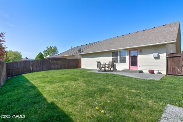 19 N 86th Ave, Yakima, WA 98908 - back of house featuring a lawn, a fenced backyard, a patio, and roof with shingles