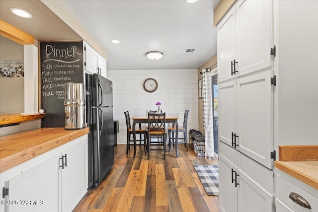 8301 Aspen Rd, Yakima, WA 98903 - kitchen with freestanding refrigerator, butcher block counters, white cabinetry, wood finished floors, and recessed lighting
