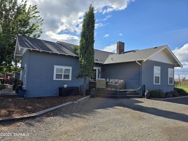 175001 W King Tull Rd, Grandview, WA 98930 - rear view of house with an outdoor hangout area, a chimney, a deck, and roof with shingles