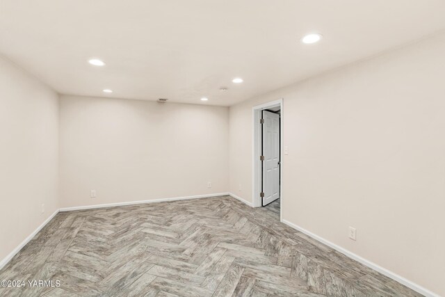 empty room with recessed lighting and baseboards