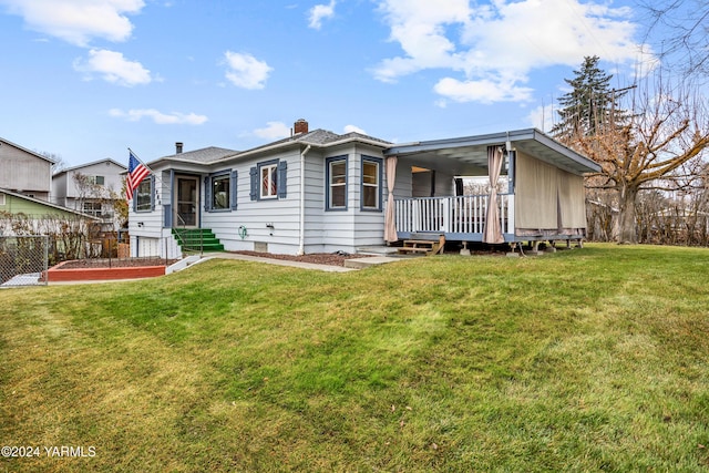 view of front of house featuring a front yard, fence, and a chimney