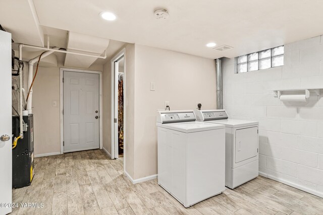 clothes washing area featuring recessed lighting, laundry area, light wood-style flooring, and separate washer and dryer