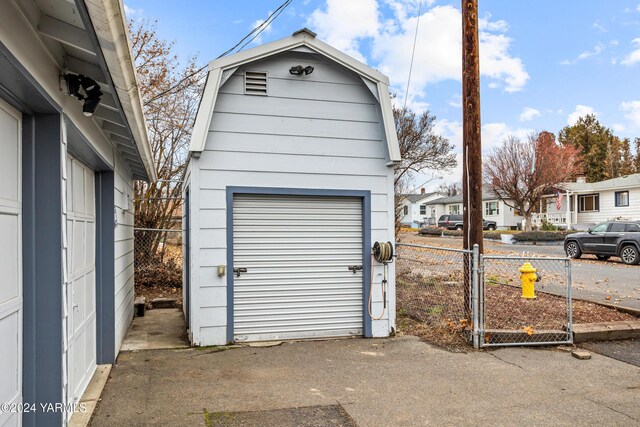 garage featuring a residential view and fence