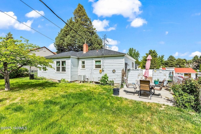 3212 W Lincoln Ave, Yakima, WA 98902 - rear view of house with a patio area, a chimney, roof with shingles, and central AC unit