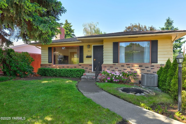 212 N 28th Ave, Yakima, WA 98902 - single story home featuring cooling unit, a front yard, a chimney, and brick siding