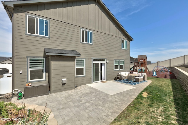 7902 W Whatcom Ave, Yakima, WA 98903 - rear view of property featuring an outdoor living space, board and batten siding, a playground, and a patio area