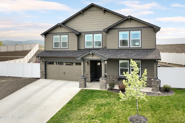 7902 W Whatcom Ave, Yakima, WA 98903 - craftsman-style house with fence, an attached garage, stone siding, a front yard, and concrete driveway