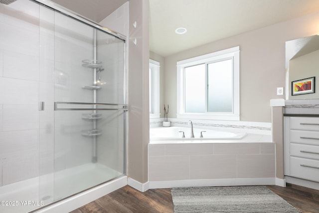7902 W Whatcom Ave, Yakima, WA 98903 - bathroom featuring a garden tub, a stall shower, wood finished floors, vanity, and baseboards