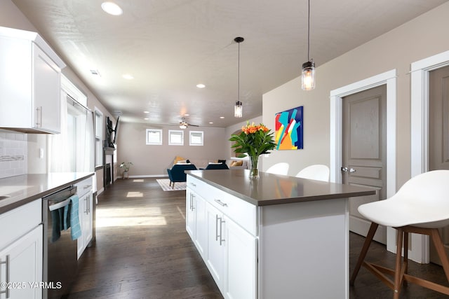 7902 W Whatcom Ave, Yakima, WA 98903 - kitchen with dark countertops, recessed lighting, dark wood-type flooring, a center island, and dishwasher