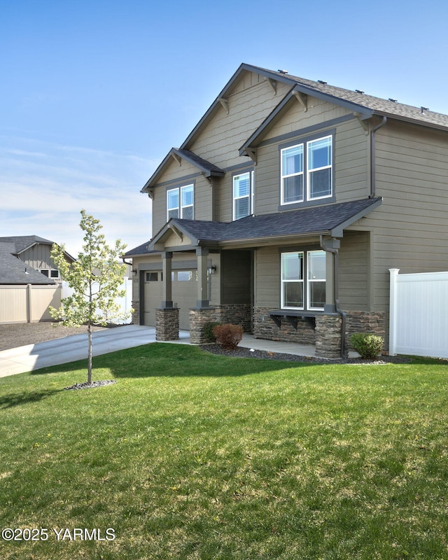 7902 W Whatcom Ave, Yakima, WA 98903 - craftsman house featuring fence, driveway, stone siding, and a front lawn