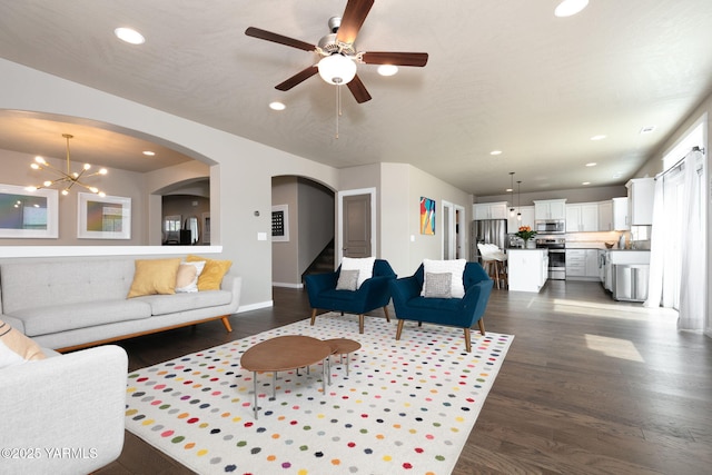 7902 W Whatcom Ave, Yakima, WA 98903 - living area featuring arched walkways, ceiling fan with notable chandelier, recessed lighting, dark wood-type flooring, and stairway