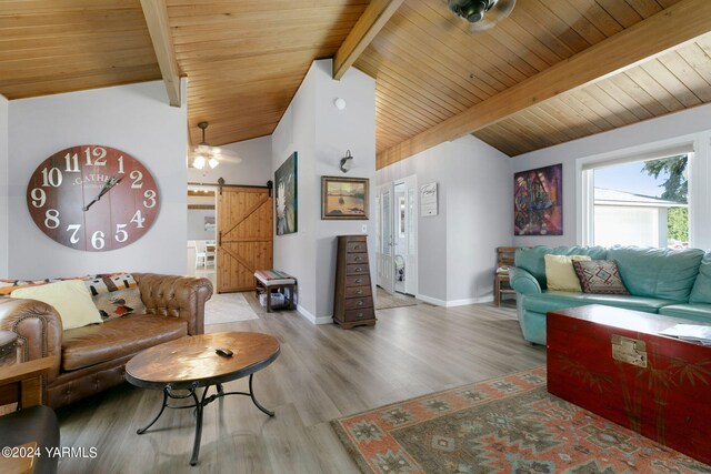 living area with a barn door, baseboards, wood ceiling, light wood-style flooring, and vaulted ceiling with beams