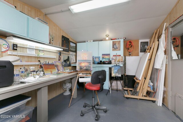 interior space with finished concrete flooring, light brown cabinetry, and lofted ceiling