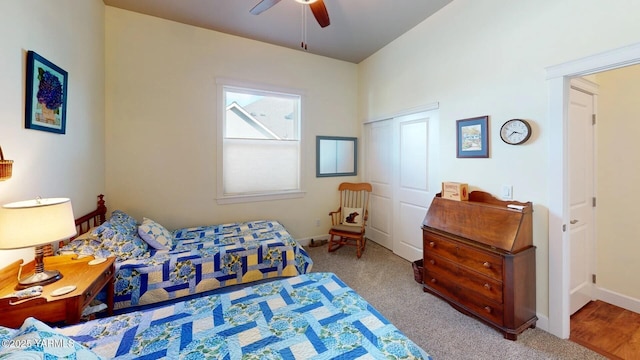 bedroom featuring carpet floors, a closet, baseboards, and a ceiling fan