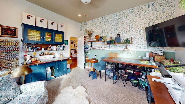 interior space with carpet flooring, a dry bar, and wallpapered walls